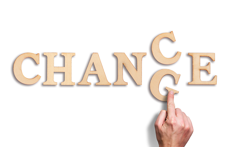 hand moving a letter, turning the word "change" to "chance"